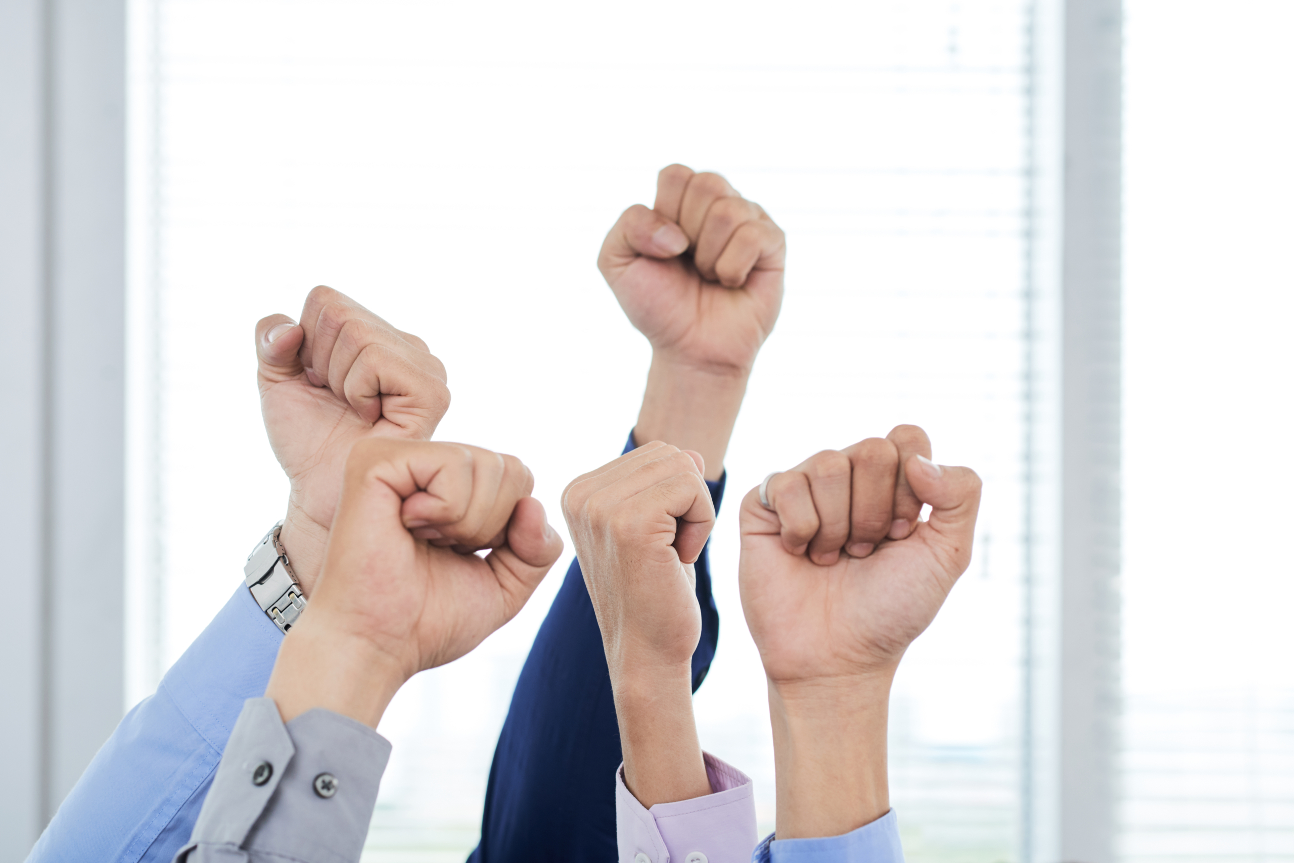 Managers Showing Clenched Fists 海外市場施策について議論するビジネスチーム